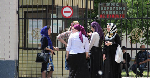 School graduates near the gate of the Unified State Examination centre. Grozny, May 2015. Photo by Magomed Magomedov for the "Caucasian Knot"