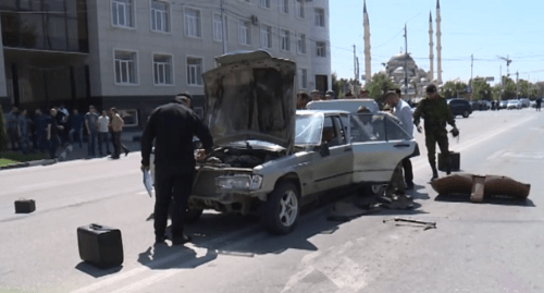 Law enforcers inspecting a car used in a series of attacks on police officers in Grozny. Screenshot of the Grozny TV Channel https://www.youtube.com/watch?v=20PJ1P7dsGY