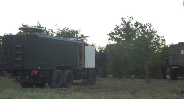 Military vehicles at the site of the counterterrorist operation (CTO) conducted by law enforcers in the forest near the village of Talgi. Screenshot of the video by the Russian National Antiterrorism Committee (NAC)