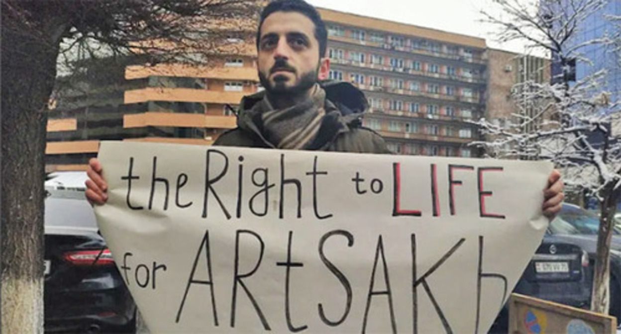 A participant of a protest action with a banner. Yerevan, March 24, 2022. Photo by Armine Martirosyan for the "Caucasian Knot"