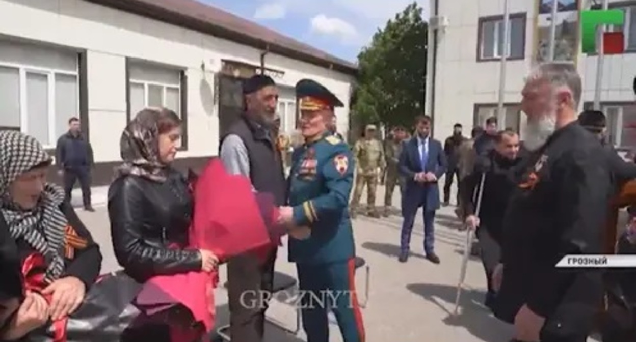 Rewarding relatives of those who died in Ukraine, May 9, 2022, Chechnya. Image made from video posted by ChGTRK ‘Grozny’ https://www.instagram.com/p/CdXlqVlDnHJ/