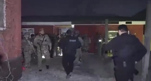 Law enforcers at the Elkhadjievs' house. Screenshot of the video by the Grozny TV channel https://t.me/groznytv/16431