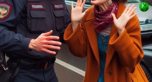 A woman and a police officer. Picture made in Photoshop by the "Caucasian Knot"