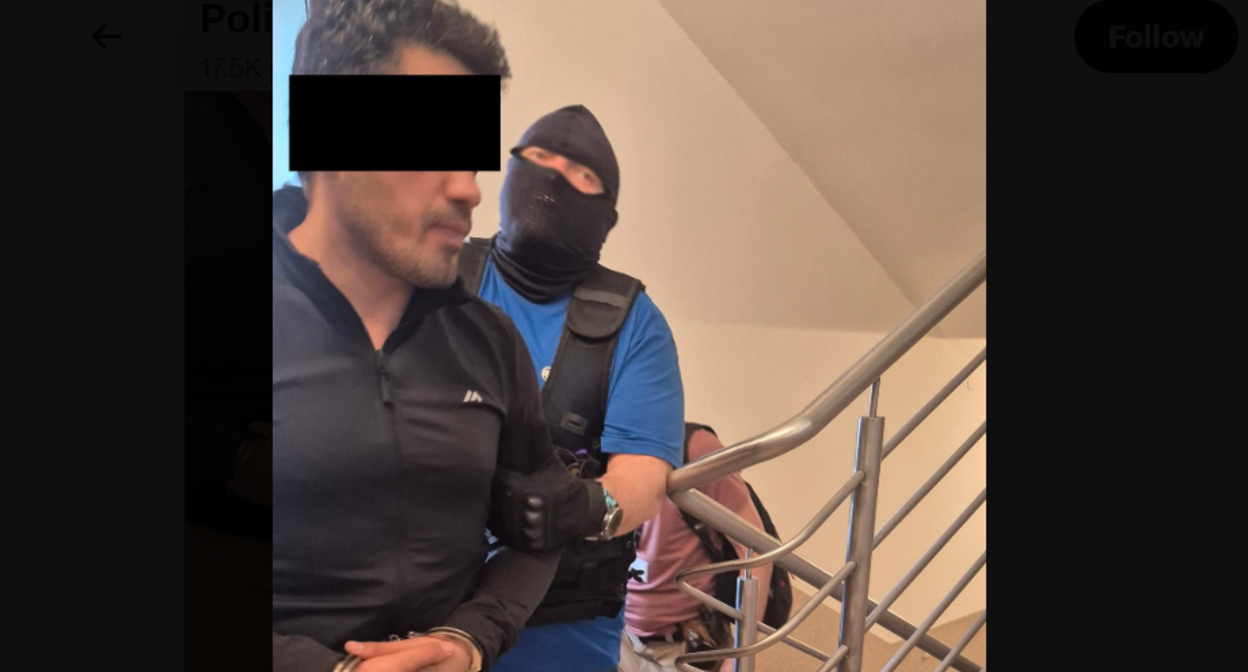 A security officer leads Elnur A. Screenshot of a Lublin police photo from 20.06.26, https://x.com/PolicjaLubelska/status/2068301027225292818/photo/1. A security officer leads Elnur A. Screenshot of a Lublin police photo from 20.06.26, https://x.com/PolicjaLubelska/status/2068301027225292818/photo/1.